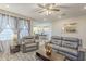 Inviting living room featuring hardwood floors, comfortable seating, and a view of the kitchen at 9920 E Tamery Ave, Mesa, AZ 85212