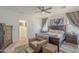 Serene main bedroom features a comfortable chair, tasteful decor, and access to a walk-in closet at 9920 E Tamery Ave, Mesa, AZ 85212