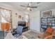 Well-lit office space features modern ceiling fan, custom curtains, comfortable sofa, and functional workspace at 9920 E Tamery Ave, Mesa, AZ 85212