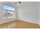 Bright bedroom with a vaulted ceiling and large window dressed with white shutters at 10304 E Plata Ave, Mesa, AZ 85212