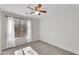 Well-lit bedroom with a ceiling fan and ample natural light at 10304 E Plata Ave, Mesa, AZ 85212