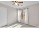 Bright bedroom with neutral paint, ceiling fan, carpet and a large window at 10304 E Plata Ave, Mesa, AZ 85212