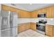 Modern kitchen boasting stainless steel appliances, light oak cabinets and tile floors at 10304 E Plata Ave, Mesa, AZ 85212