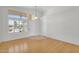 Inviting living room with a large window letting in natural light and view, and door to the side at 10304 E Plata Ave, Mesa, AZ 85212