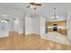 Bright, open-concept living room showcasing hardwood floors and seamless flow to the kitchen at 10304 E Plata Ave, Mesa, AZ 85212