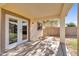 Covered patio featuring double doors and access to the backyard with privacy wall at 10304 E Plata Ave, Mesa, AZ 85212
