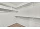 A clean and organized walk-in closet with ample shelving and storage space at 10304 E Plata Ave, Mesa, AZ 85212