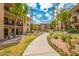 Beautifully landscaped community with lush gardens, walking paths, and inviting outdoor spaces under a partly cloudy sky at 10330 W Thunderbird Blvd # C109, Sun City, AZ 85351