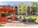 Charming gazebo overlooking a tranquil pond and landscaped garden within a multi-story building complex at 10330 W Thunderbird Blvd # C109, Sun City, AZ 85351