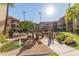 Courtyard featuring a charming bridge, pond, lush plants, and multi-story residences at 10330 W Thunderbird Blvd # C109, Sun City, AZ 85351