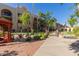 Beautifully landscaped courtyard with pond, decorative bridge, vibrant plants, and multi-story buildings at 10330 W Thunderbird Blvd # C109, Sun City, AZ 85351