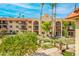 Multi-story residences overlook a serene landscaped courtyard with a decorative bridge and cascading water features at 10330 W Thunderbird Blvd # C109, Sun City, AZ 85351