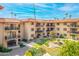 Multi-story residence with balconies overlooking a beautifully landscaped courtyard, pond, and mature landscaping at 10330 W Thunderbird Blvd # C109, Sun City, AZ 85351