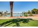 Picturesque view of a tranquil lake, surrounded by palm trees, greenery, and scenic landscape at 10330 W Thunderbird Blvd # C109, Sun City, AZ 85351