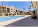 Community pool surrounded by lounge chairs and well-maintained landscaping at 10330 W Thunderbird Blvd # C109, Sun City, AZ 85351