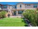 Spacious backyard with green lawn, mature bushes and patio area at 1055 W Diamondback Dr, Chandler, AZ 85286