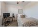 Comfortable bedroom with a dedicated workspace, desk, and natural lighting at 1055 W Diamondback Dr, Chandler, AZ 85286