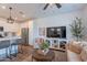 Bright living room features a modern, open floor plan with stainless steel appliances and wood flooring at 1055 W Diamondback Dr, Chandler, AZ 85286
