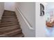 Wooden staircase features a white handrail and leads to the upper level at 1055 W Diamondback Dr, Chandler, AZ 85286