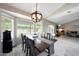 Inviting dining area features a large table, modern chandelier, and views of the backyard at 11446 N 109Th St, Scottsdale, AZ 85259