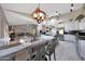 Elegant dining area with modern lighting and access to the living spaces and kitchen at 11446 N 109Th St, Scottsdale, AZ 85259