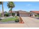 Charming single-story home featuring a well-manicured front yard and a two-car garage at 11446 N 109Th St, Scottsdale, AZ 85259
