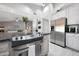 Spacious kitchen boasts stainless steel appliances and island with a breakfast bar at 11446 N 109Th St, Scottsdale, AZ 85259