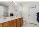 Bathroom with double sinks, wood cabinets, shower with glass door and separated toilet room at 1341 E Bellerive Dr, Chandler, AZ 85249