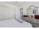 Light and airy bedroom with silver dresser, sliding door closet and ensuite bath at 1341 E Bellerive Dr, Chandler, AZ 85249