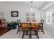 Dining area featuring a wooden table, tile floors and plantation shutters at 1341 E Bellerive Dr, Chandler, AZ 85249