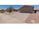 Charming home exterior featuring a two-car garage, desert landscaping, and a spacious driveway at 1341 E Bellerive Dr, Chandler, AZ 85249