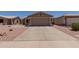 Home featuring a two-car garage with a wide driveway and desert landscaping at 1341 E Bellerive Dr, Chandler, AZ 85249