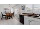 Eat-in kitchen with wood table and chairs, granite counters, white cabinets and lots of natural light at 1341 E Bellerive Dr, Chandler, AZ 85249