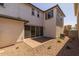 A backyard showcasing the exterior of the home with a patio and low maintenance landscaping at 13465 N 158Th Ave, Surprise, AZ 85379