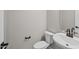 Compact powder room featuring a white toilet and sink with modern black hardware and finishes at 13465 N 158Th Ave, Surprise, AZ 85379