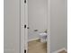 Small powder room with hardwood floors and a modern elongated toilet at 13465 N 158Th Ave, Surprise, AZ 85379