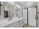 Modern bathroom featuring a double sink vanity, sleek black fixtures, and a frameless glass shower at 13465 N 158Th Ave, Surprise, AZ 85379