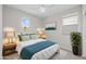 Cozy bedroom with a queen-sized bed, two side tables, coordinated lamps and decor with a neutral color palette at 13465 N 158Th Ave, Surprise, AZ 85379