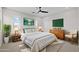 Staged bedroom with a comfortable bed, stylish decor, and natural light from two windows at 13465 N 158Th Ave, Surprise, AZ 85379