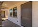 Inviting front entryway showcasing a modern door, stone pillar accents, and a glimpse of the interior at 13465 N 158Th Ave, Surprise, AZ 85379
