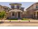 Charming home with a covered porch, stone pillars, front lawn, and neutral exterior at 13465 N 158Th Ave, Surprise, AZ 85379