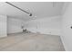 Spacious two-car garage interior featuring concrete floors and white walls at 13465 N 158Th Ave, Surprise, AZ 85379
