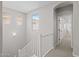 Bright hallway with natural light, white staircase, and access to rooms upstairs at 13465 N 158Th Ave, Surprise, AZ 85379