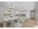 Open-concept kitchen featuring white cabinets, granite countertops, a kitchen island, and adjacent dining area at 13465 N 158Th Ave, Surprise, AZ 85379
