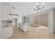 Open-concept kitchen featuring white cabinets, granite countertops, a kitchen island, and sliding glass doors at 13465 N 158Th Ave, Surprise, AZ 85379