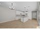 Open-concept kitchen featuring white cabinets, granite countertops, a kitchen island, and tile floors at 13465 N 158Th Ave, Surprise, AZ 85379