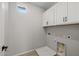 Practical laundry room featuring tiled floors, ample cabinet space and laundry hookups at 13465 N 158Th Ave, Surprise, AZ 85379