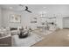Beautifully staged living area with a cozy sofa, stylish decor, and an open layout connecting to the kitchen at 13465 N 158Th Ave, Surprise, AZ 85379