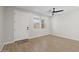 Bright living room features a ceiling fan, wood-look tile flooring, and a window with a view of the neighborhood at 13465 N 158Th Ave, Surprise, AZ 85379