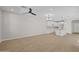 Spacious open-concept living area with modern light fixtures, tile flooring, and a seamless flow to the kitchen at 13465 N 158Th Ave, Surprise, AZ 85379